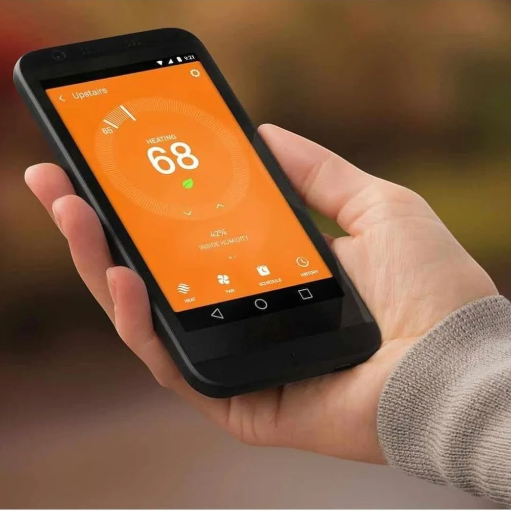 Smartphone controlling Google Nest Thermostat for hot water via app